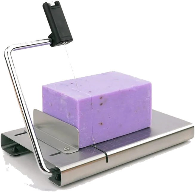 Adjustable soap cutter slicing a lavender soap loaf